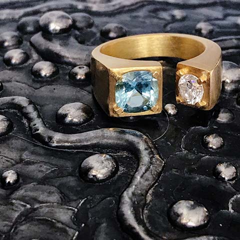 Hand carved 18k gold ring set with a Brazilian aquamarine next to a white diamond by Jane Bartel Jewelry