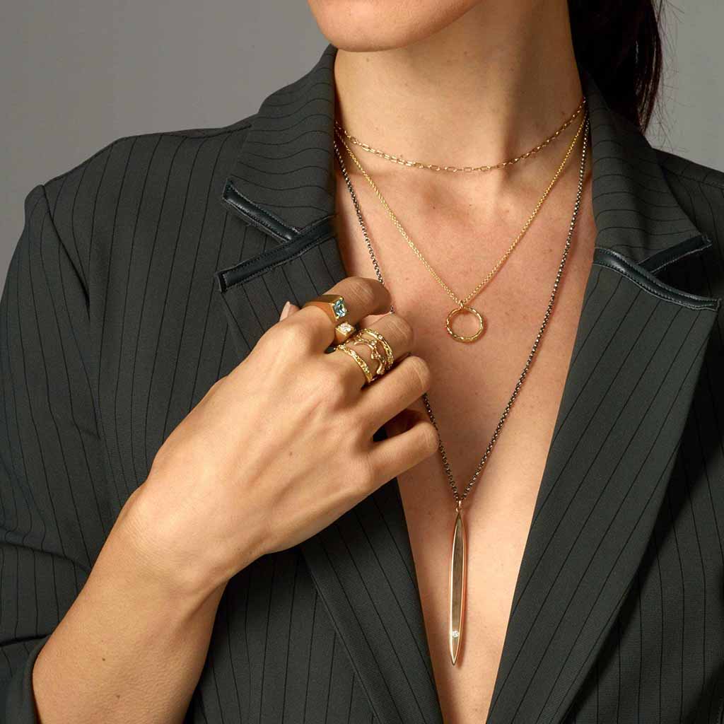 model wearing the 18k gold circle of love necklace by Jane Bartel
