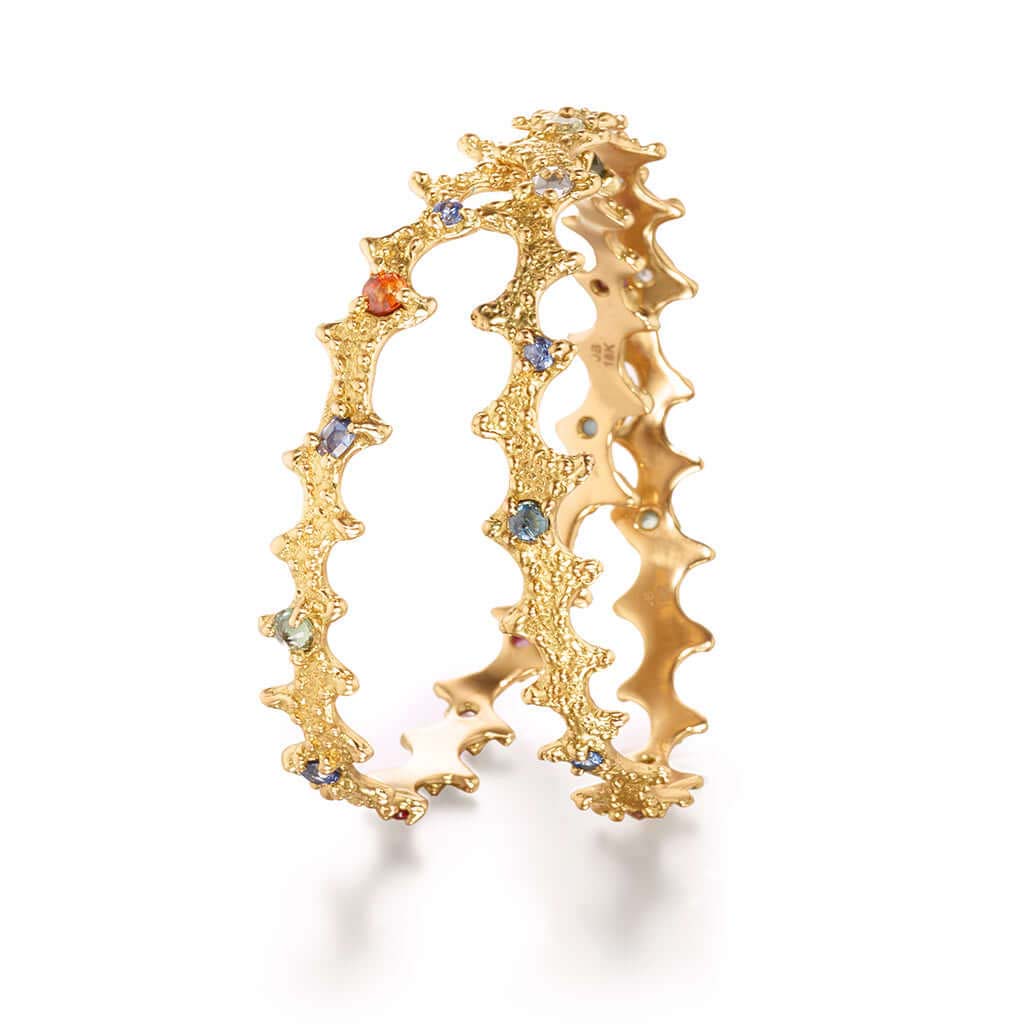 Pair of 18k gold colored sapphire bangles with texture inspired by a sea urchin sea shell. Ocean inspired fine jewelry by Jane Bartel
