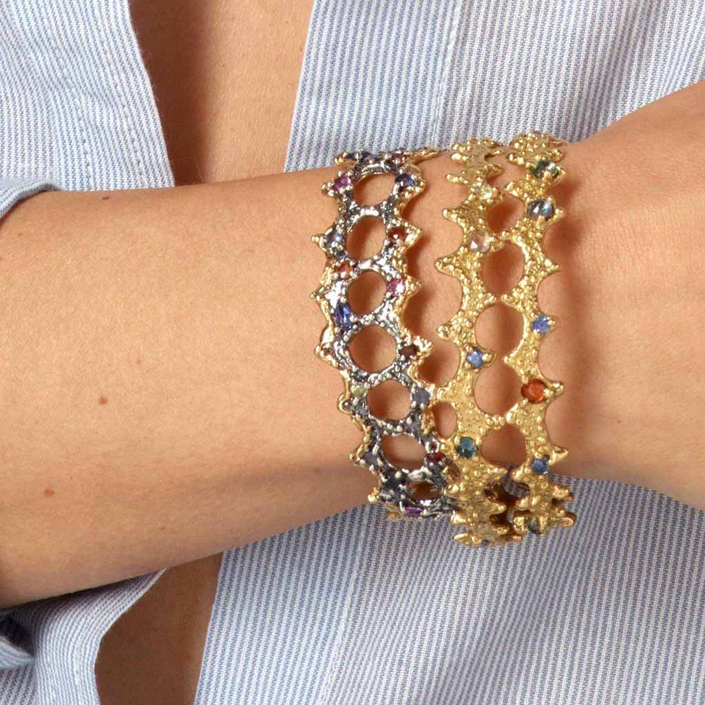 Group of stacking 18k gold colored sapphire bangles by Jane Bartel Jewelry