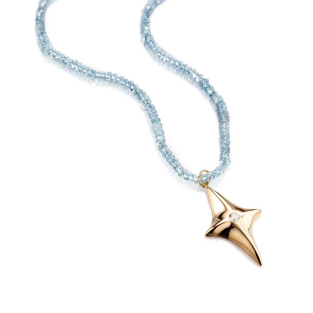 14k gold star pendant necklace set with a white diamond on knotted blue topaz beads by Jane Bartel