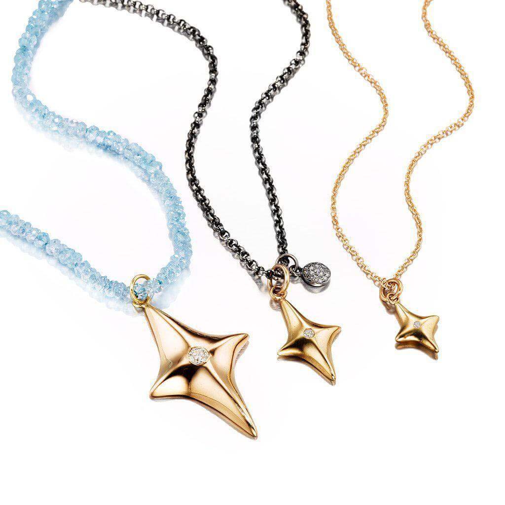 14k gold star pendant necklace set with a white diamond on knotted blue topaz beads by Jane Bartel