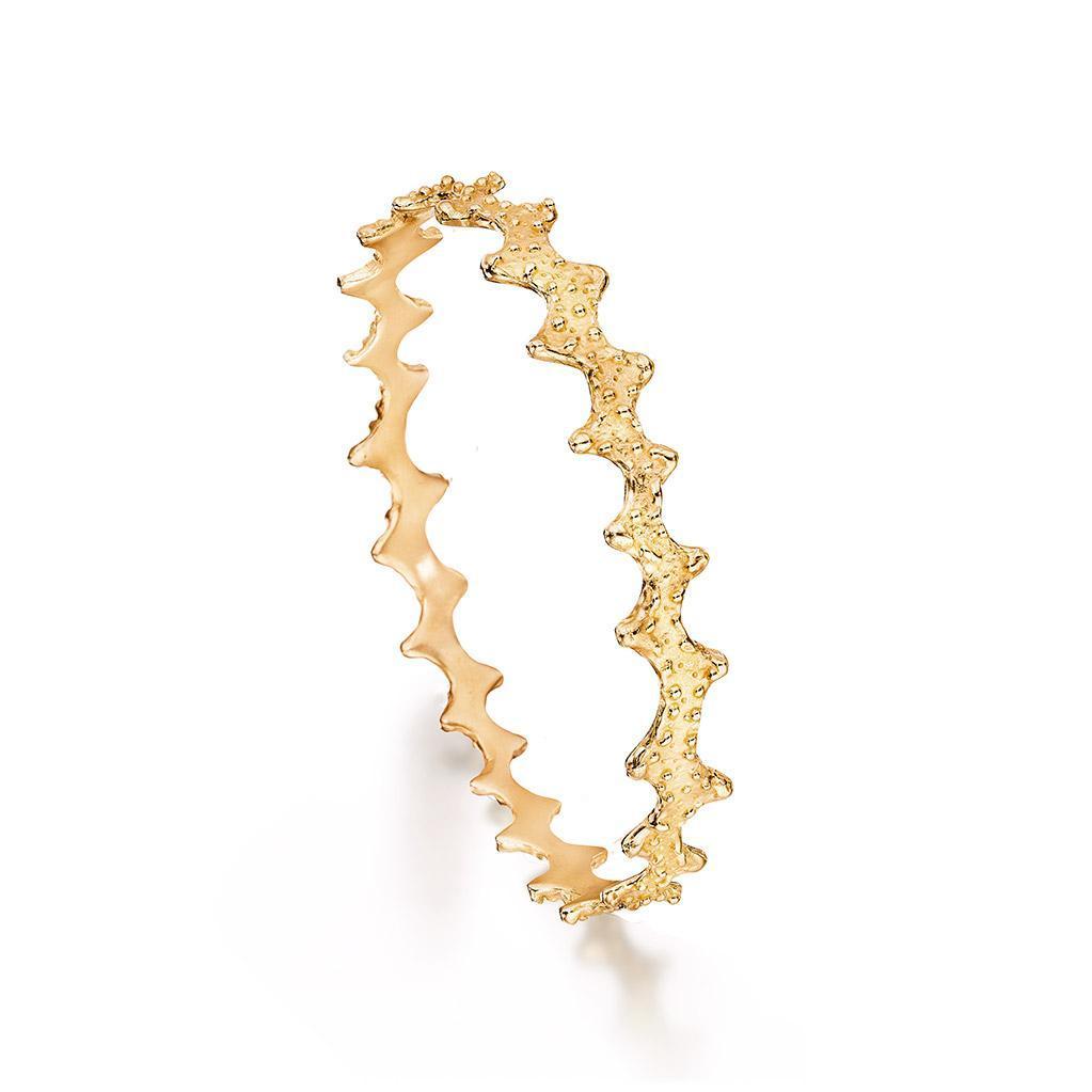 Handcrafted 18k solid gold bangle bracelet with texture inspired by a sea urchin shell. Ocean inspired jewelry by Jane Bartel