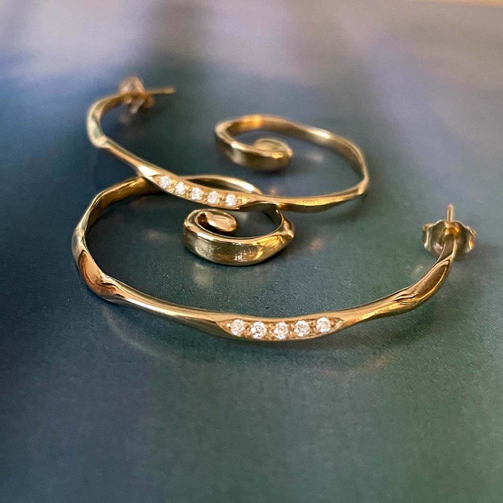 Handcrafted 14k gold and diamond spiral hoop earrings by Jane Bartel
