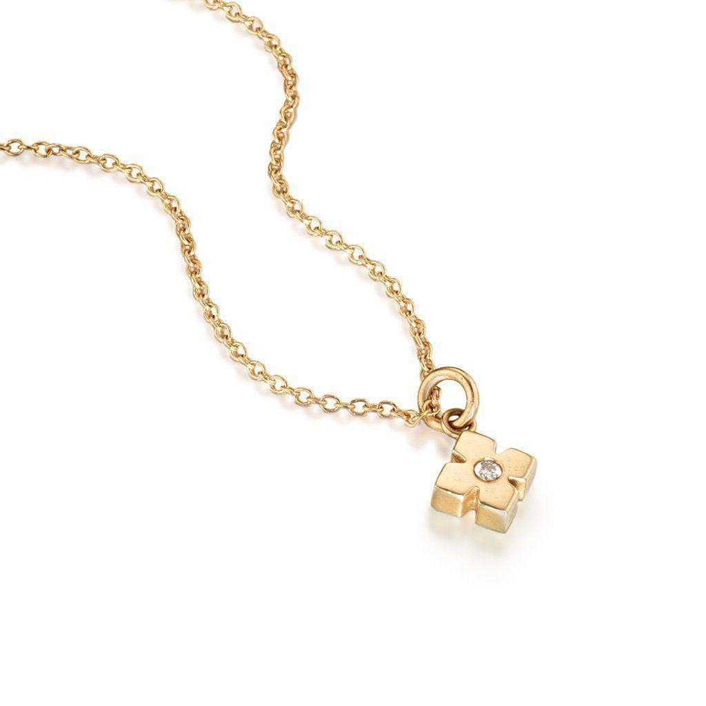 modern star 14k gold necklace set with a white diamond by Jane Bartel