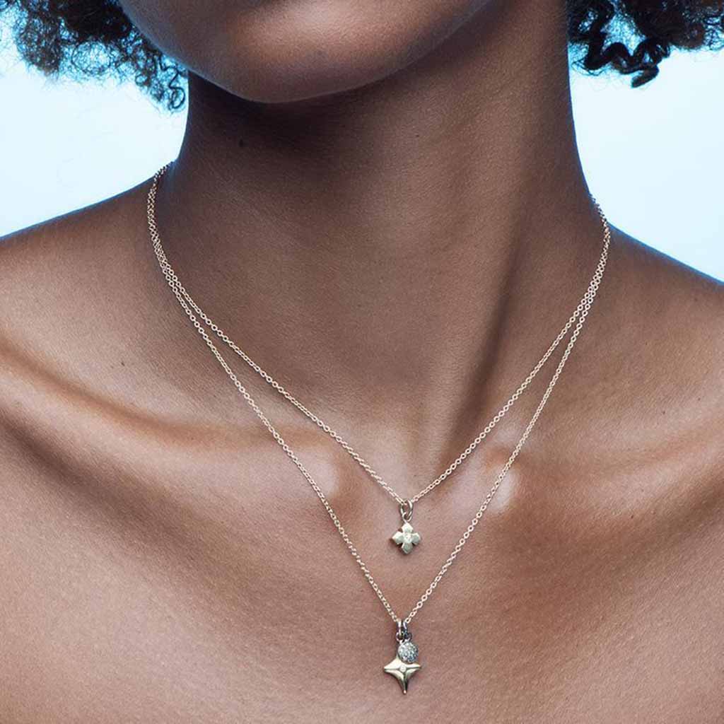 modern star 14k gold necklace set with a white diamond by Jane Bartel