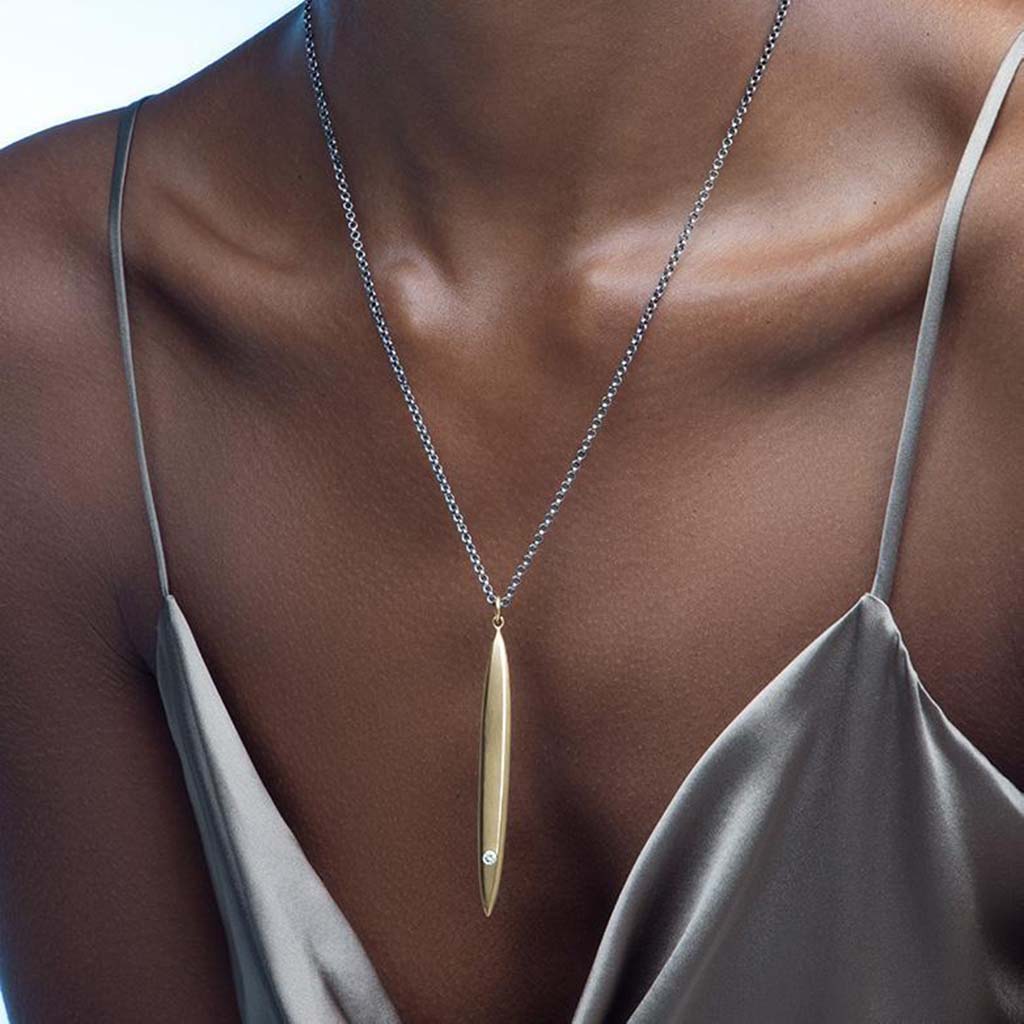 Long modern gold surfboard necklace in 14k gold on an oxidized sterling silver chain by Jane Bartel Jewelry